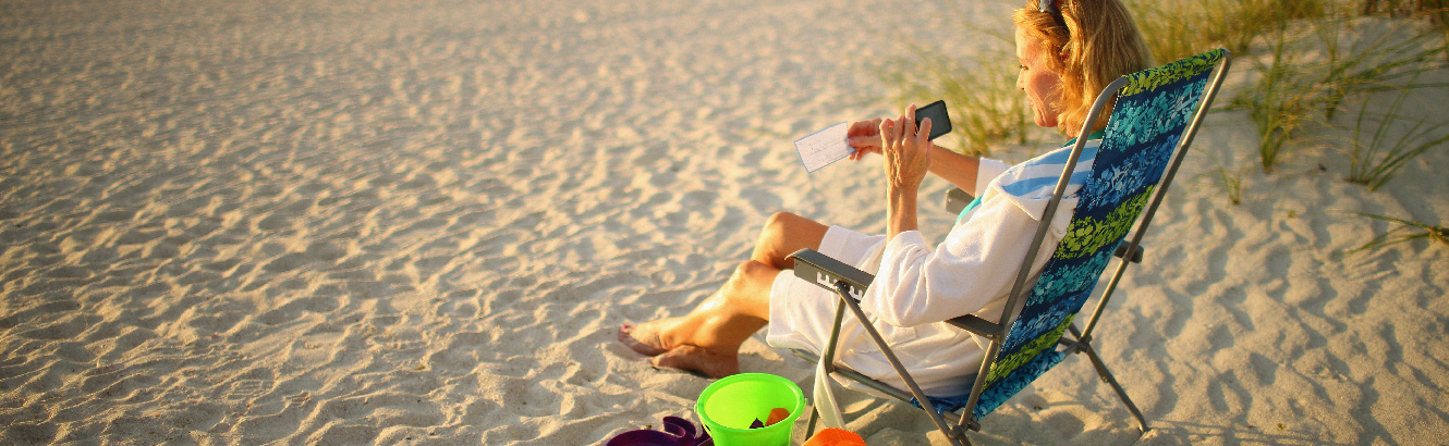 woman sitting in a beach chair on a beach